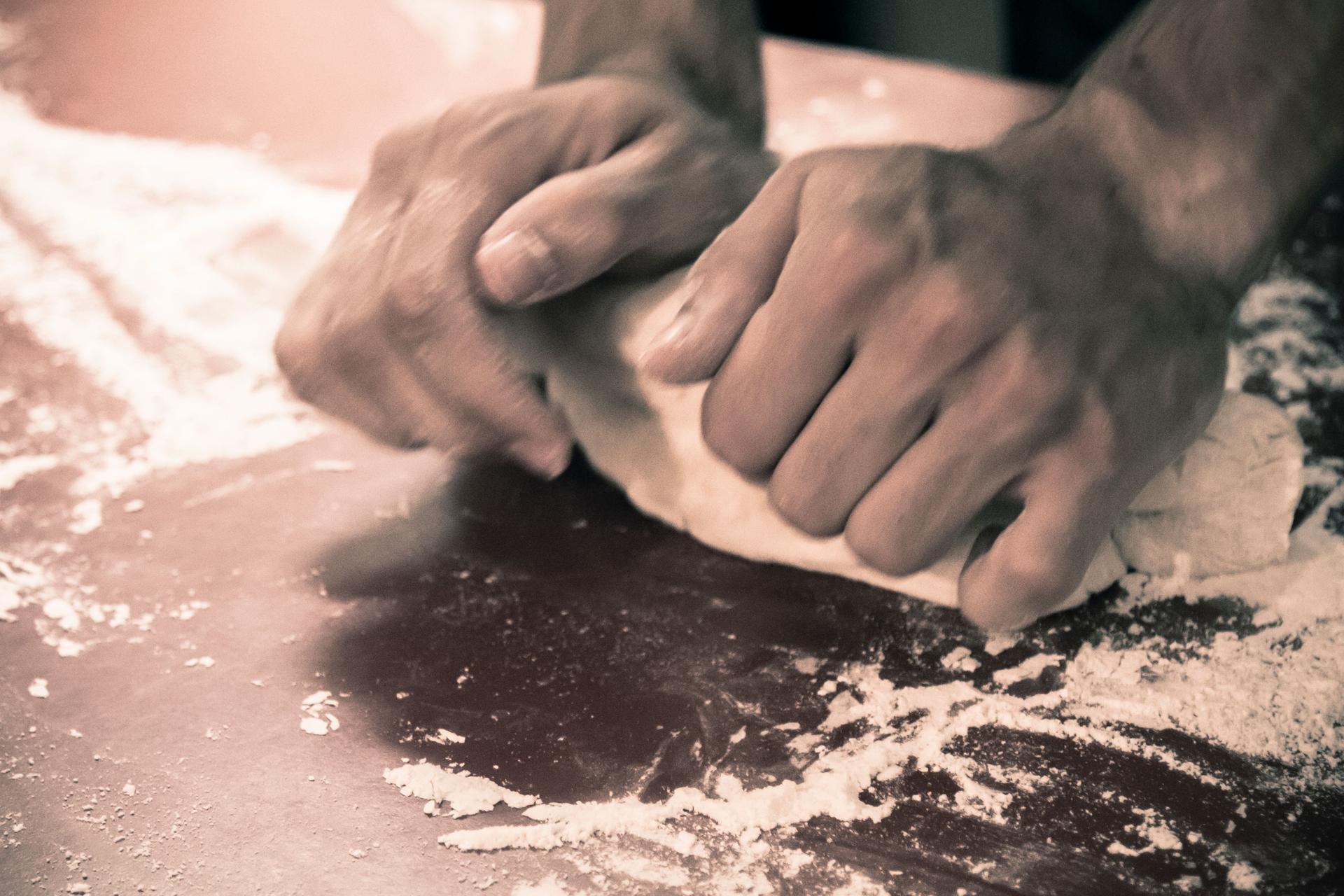 Hands baking chilean empanadas